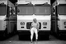 Girl posing for portrait photography sitting by a mail truck