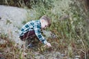 little boy playing rocks