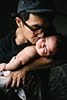 dad kissing his newborn son