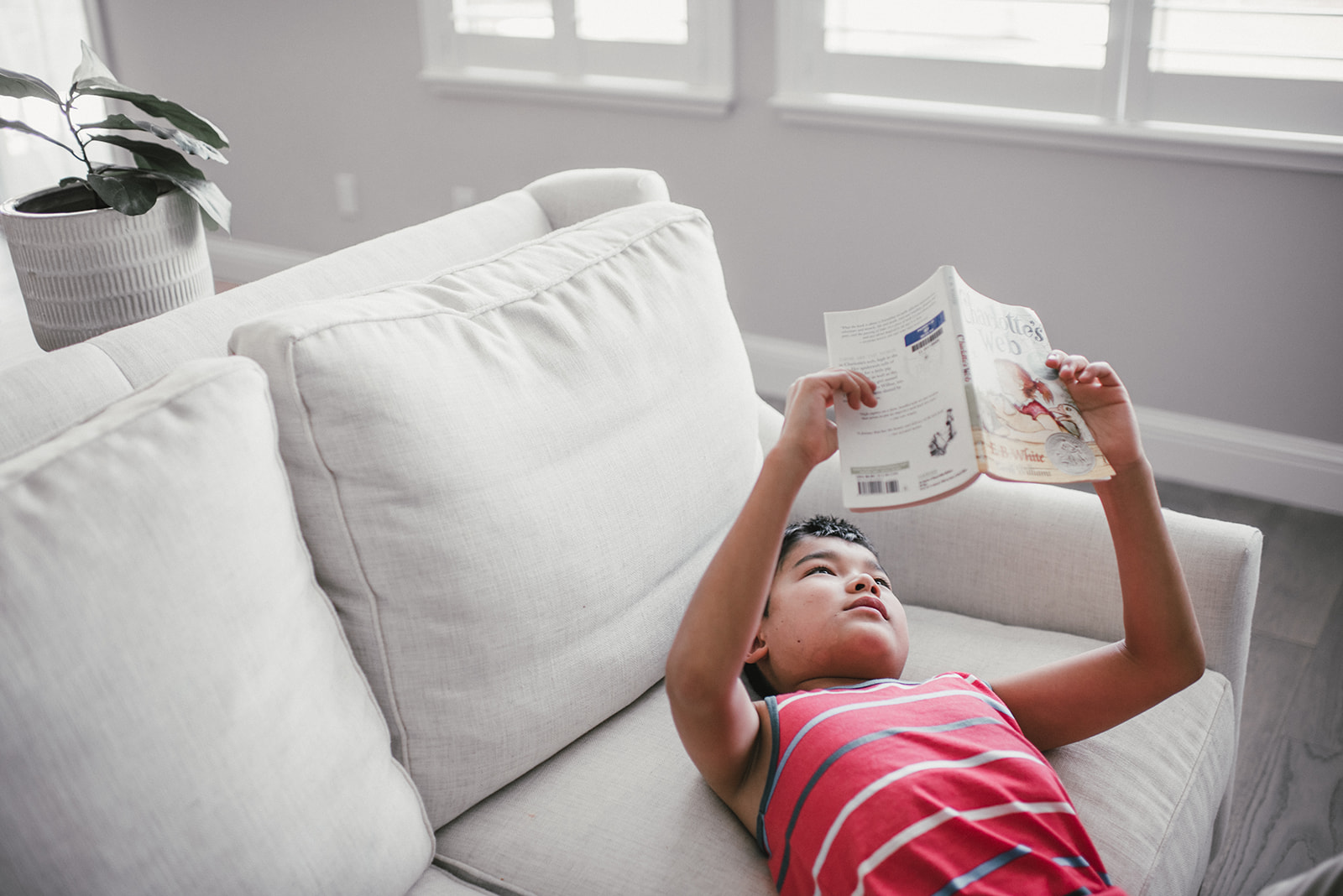 little boy in red reading