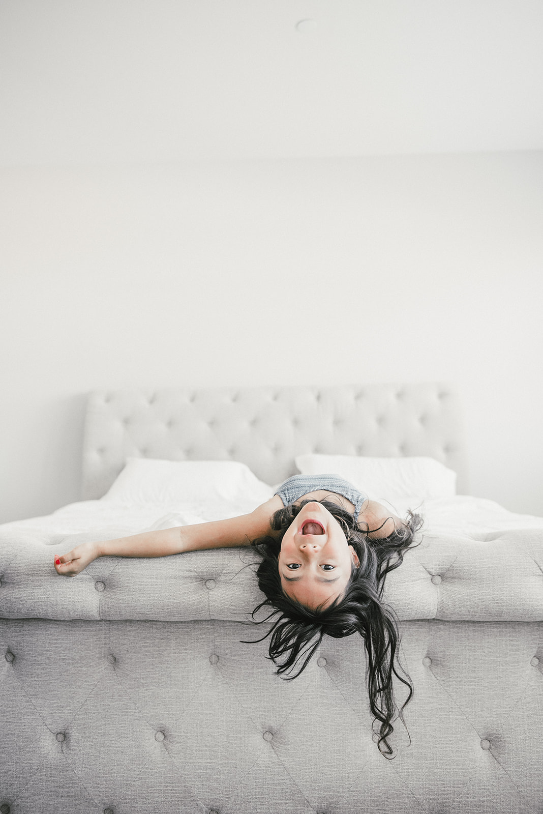 little kid playing on bed