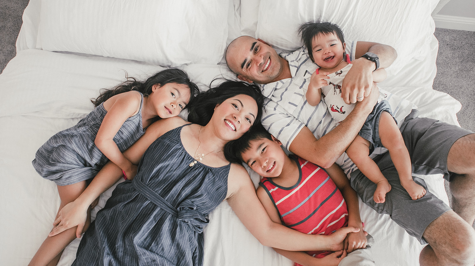 whole family laying on the bed