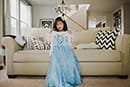 little girl holding a princess dress