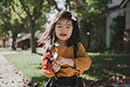 little girl holding leaves