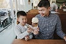 dad enjoying ice cream with son
