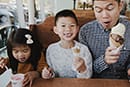 dad, big brother, and little sister enjoying ice cream