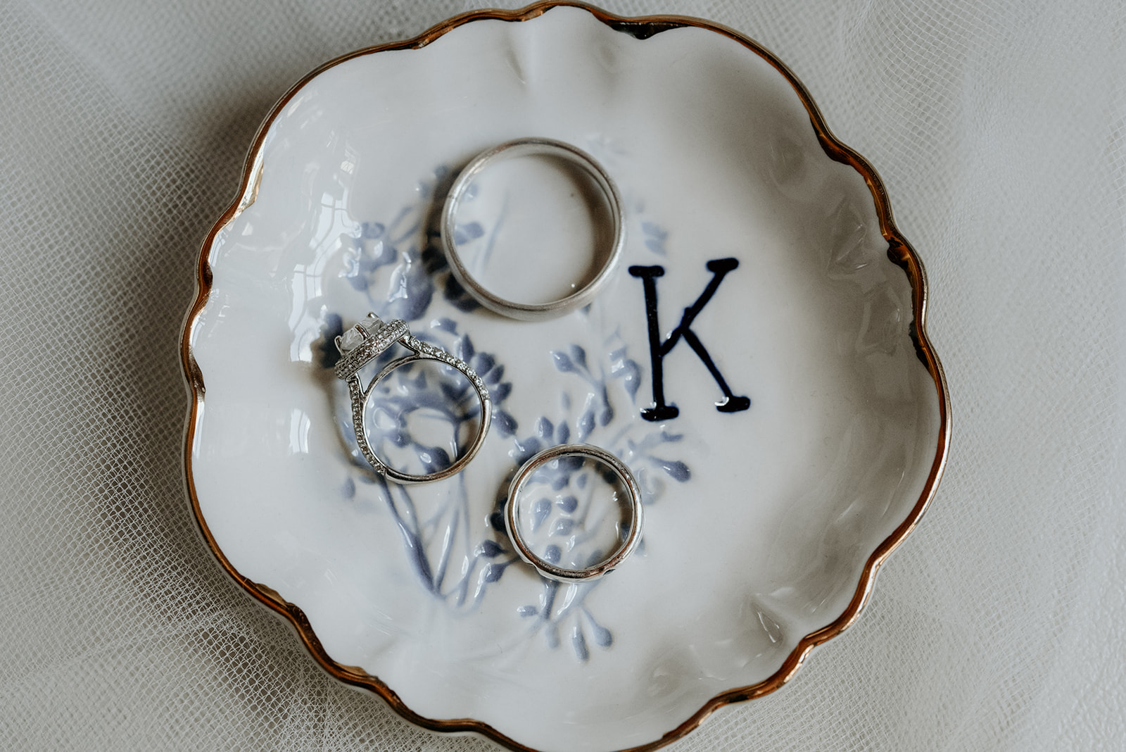 wedding rings in blue and white ring dish