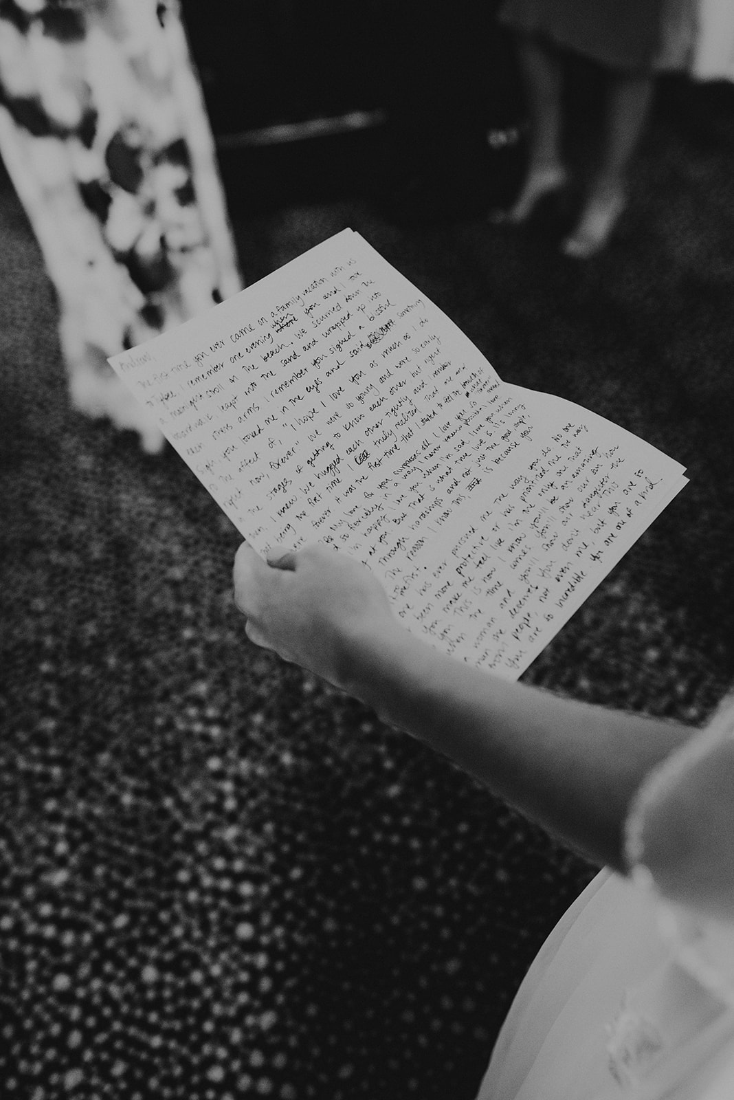 bride holding written wedding vows