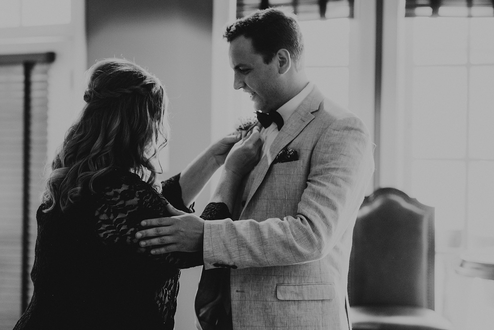 mother of groom putting on his boutonnière