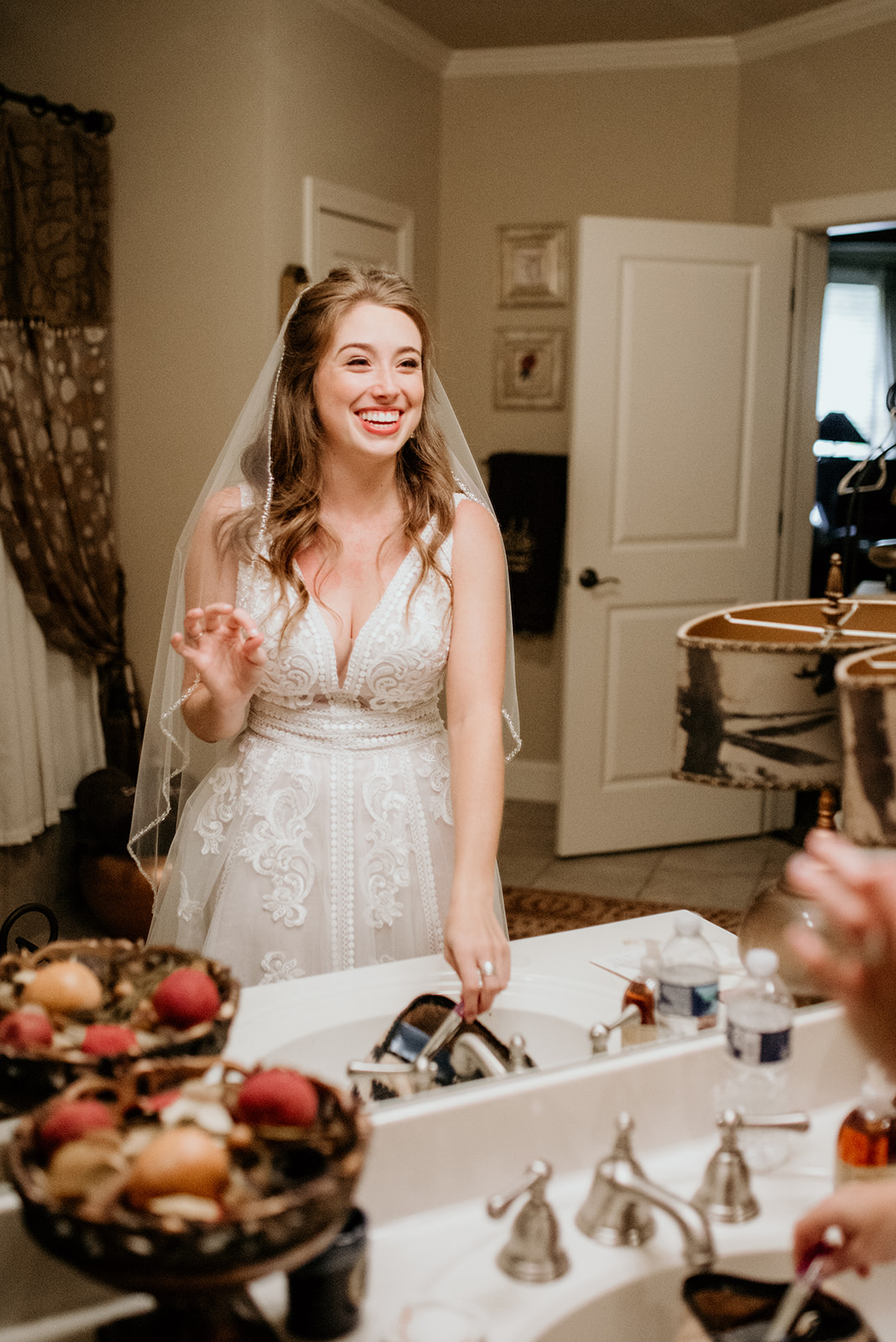 bride looking in mirror smiling