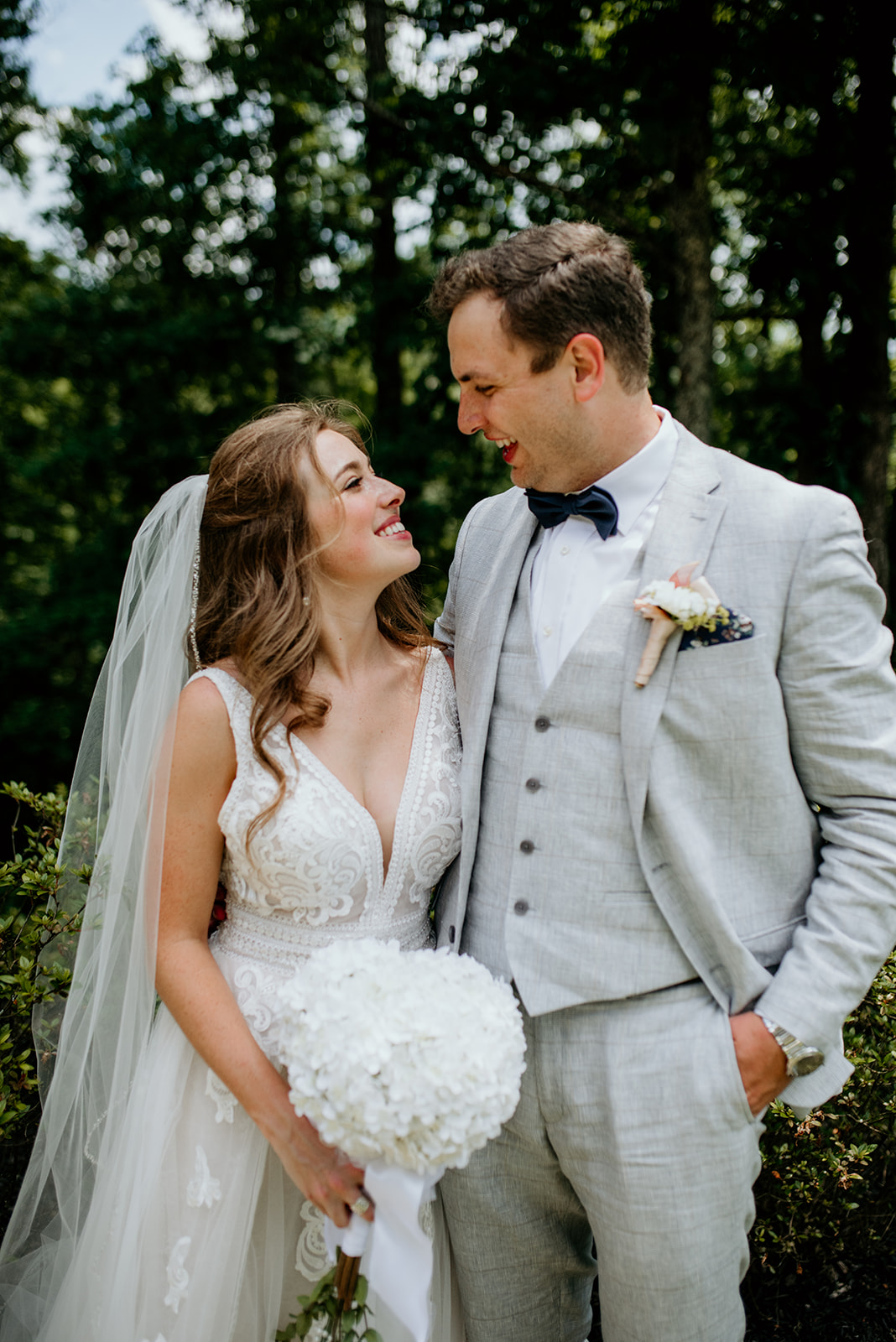 bride and groom smiling at each other