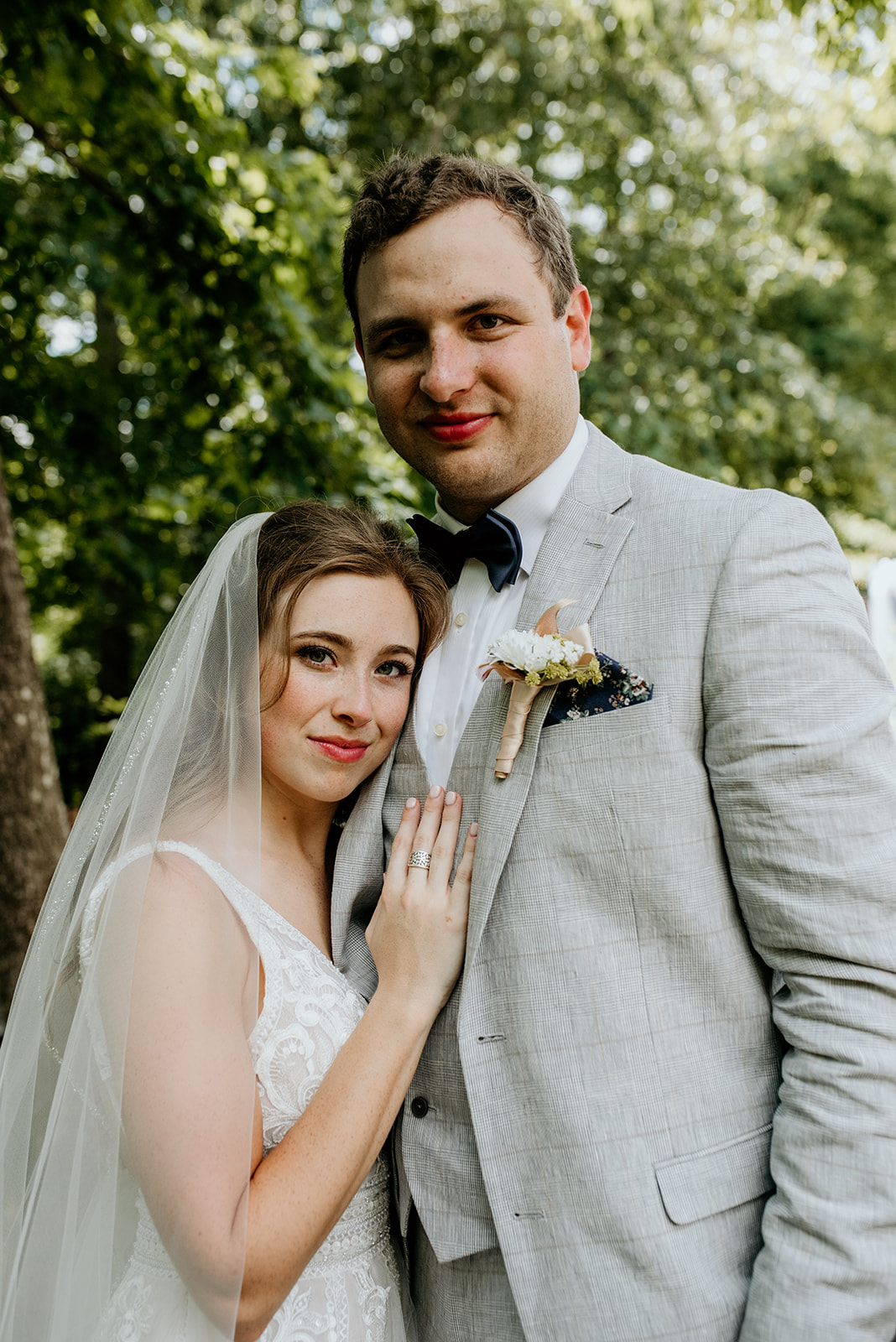 bride and groom with brides hand on grooms chest