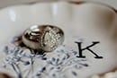 wedding rings in ring dish with K engraved in dish