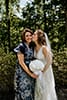 bride kissing her mother on the cheek