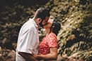 Couple kissing in forest during Hawaiian Engagement photoshoot