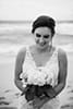 bride wearing beaded dress holding bouquet black and white