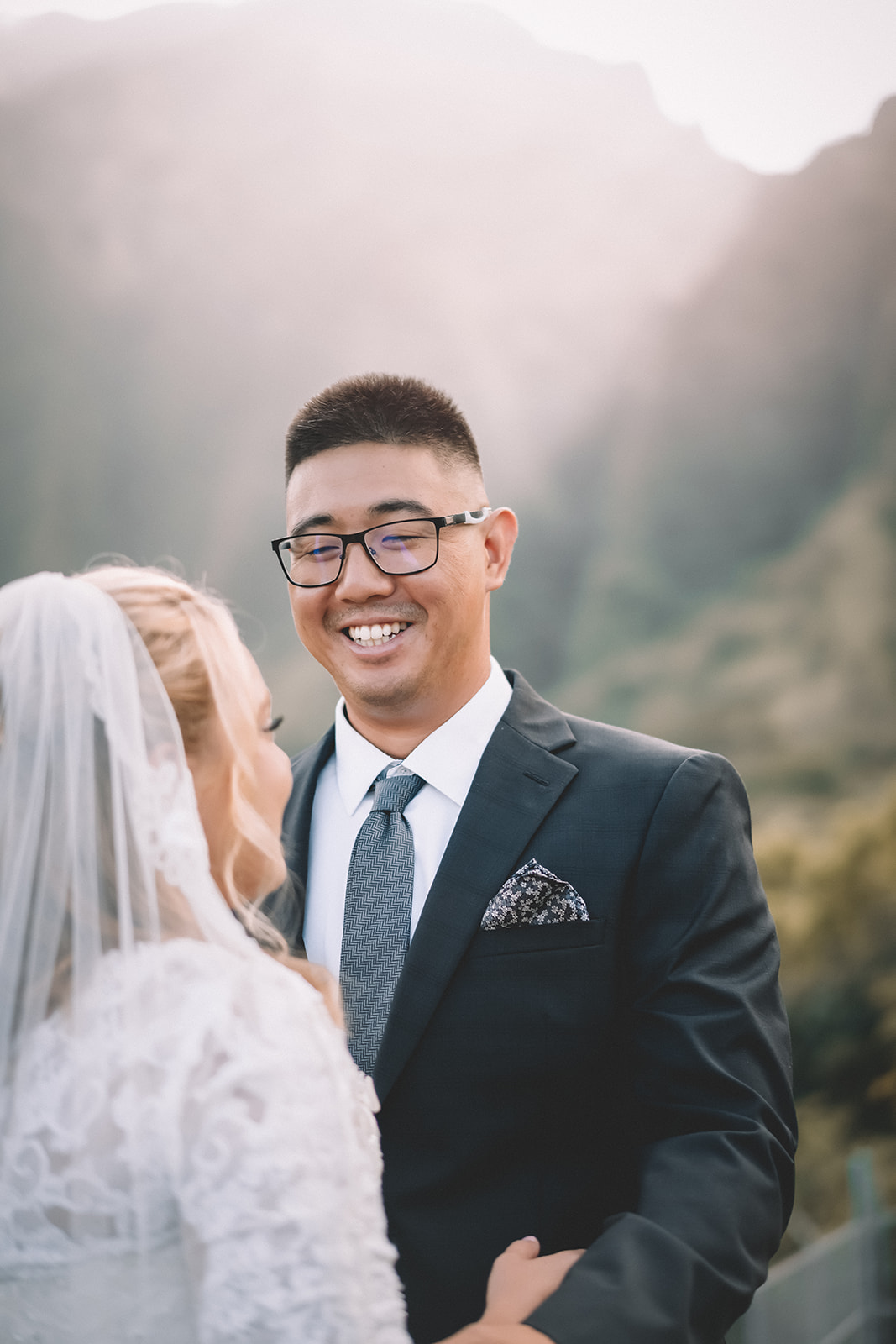 Groom smiling Hoomaluhia botanical garden