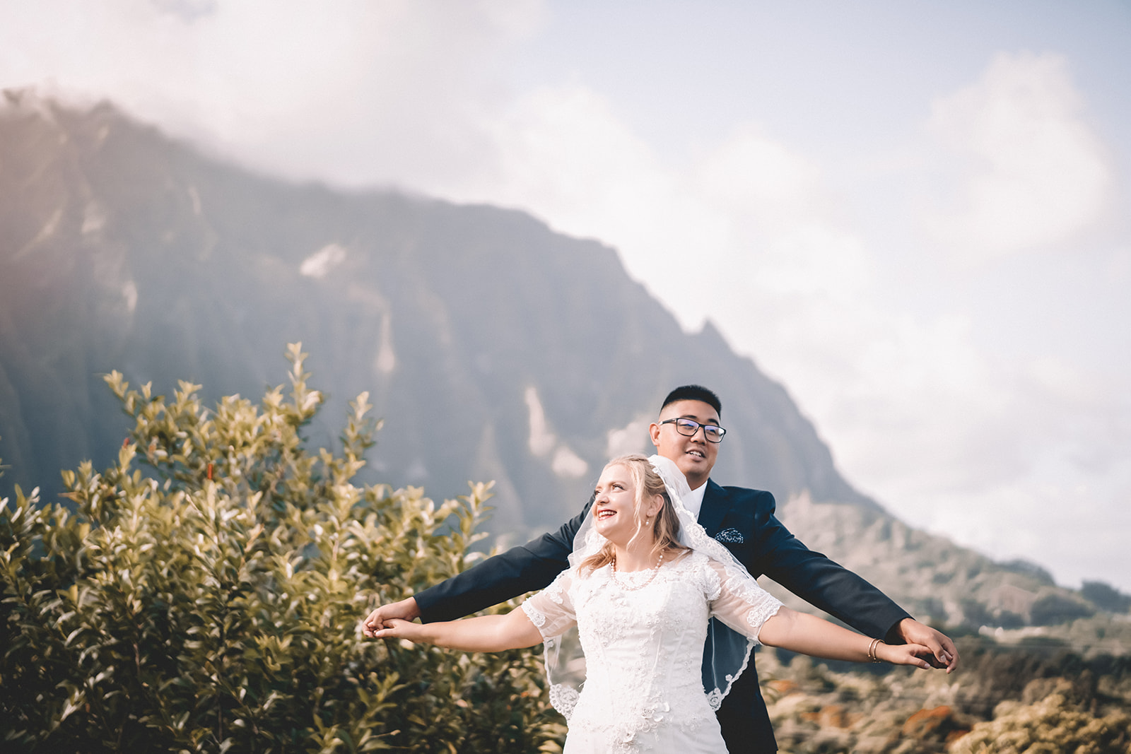 bride and groom holding each other hoomaluhia botanical garden
