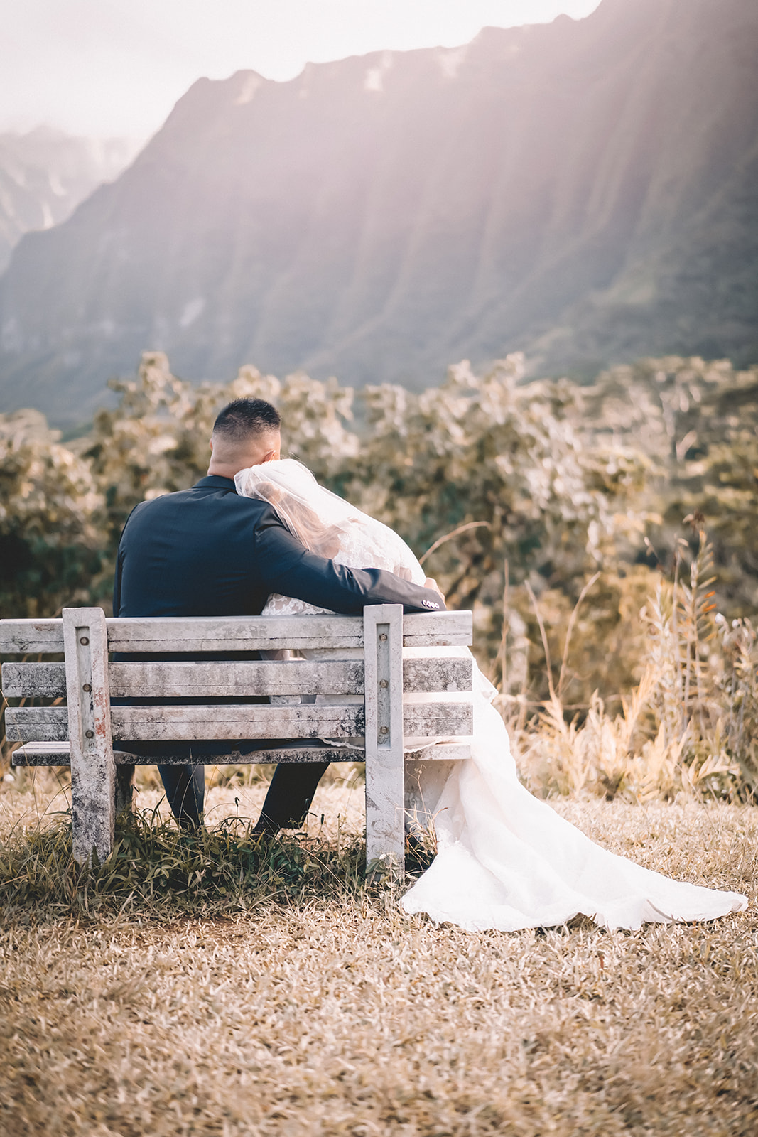 bride resting head on groom's shoulder hoomaluhia botanical garden