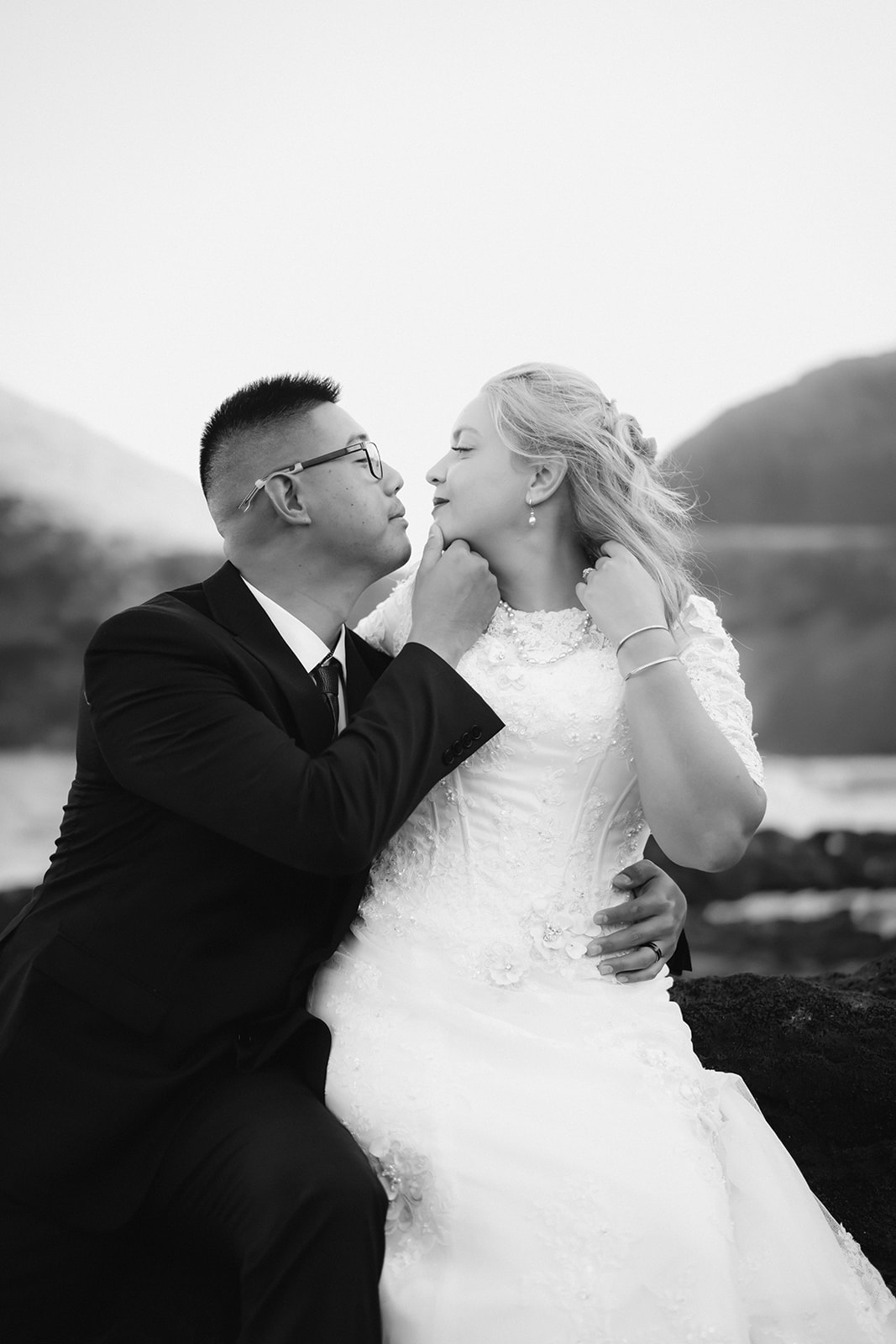 engaged couple caressing face makapuu beach black and white