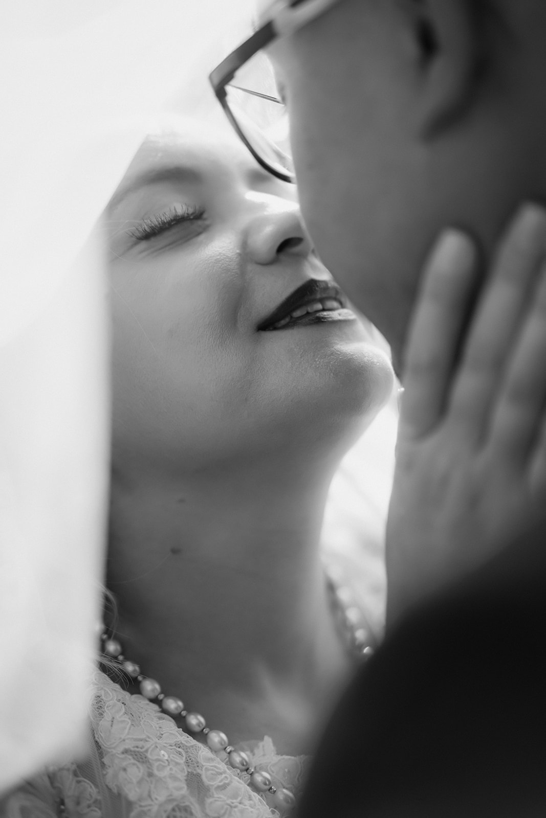 black and white bride eyes closed almost kissing groom
