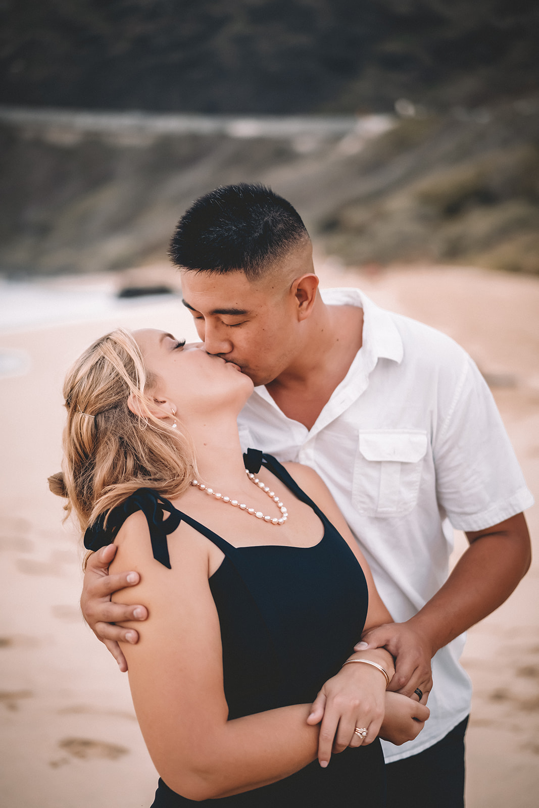man and woman kissing makapuu beach hawaii