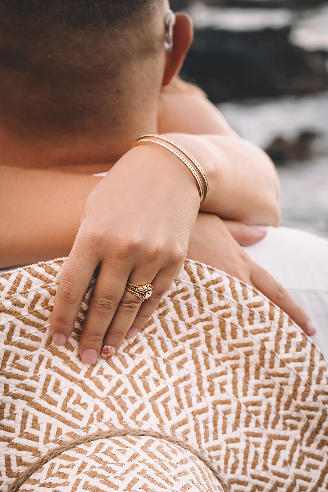 woman holding sunhat showing wedding ring