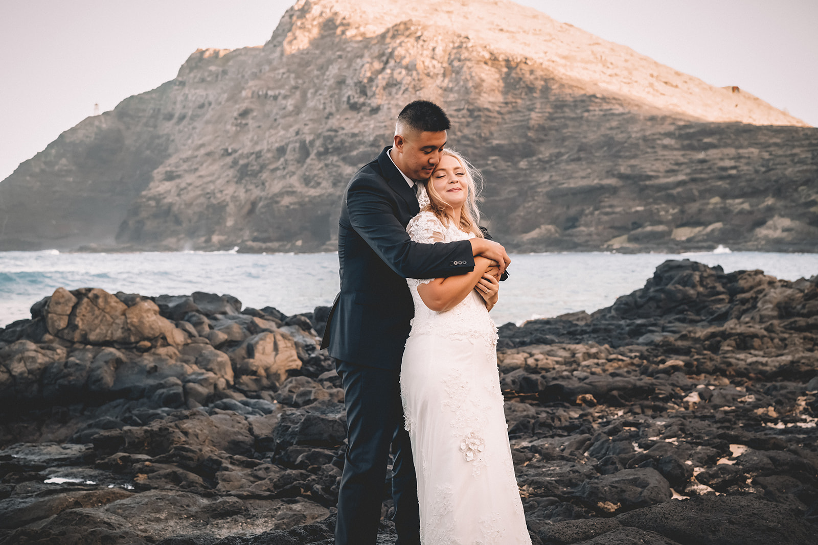 man embracing woman from behind makapuu beach