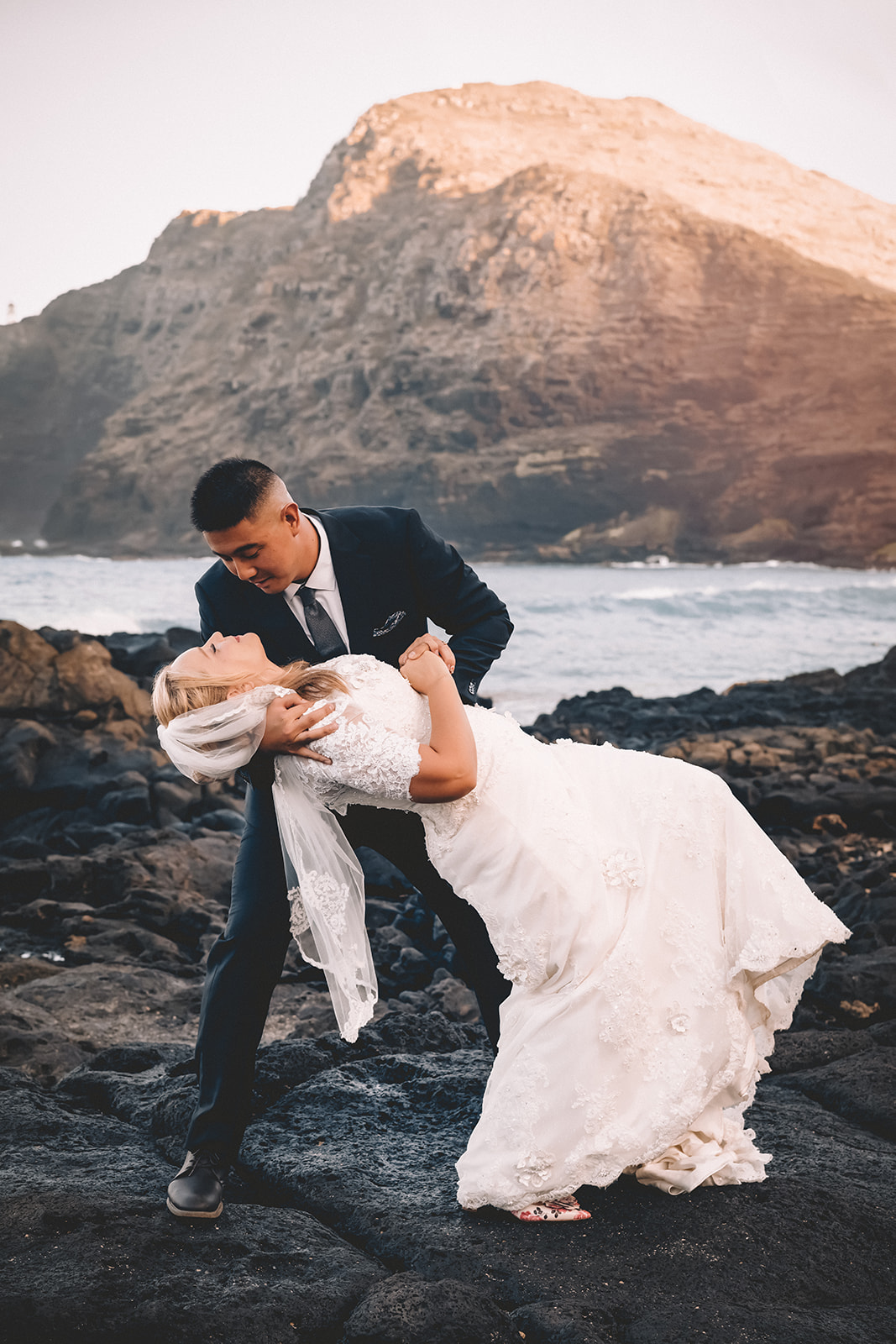 man dipping wife dancing makapuu beach hawaii