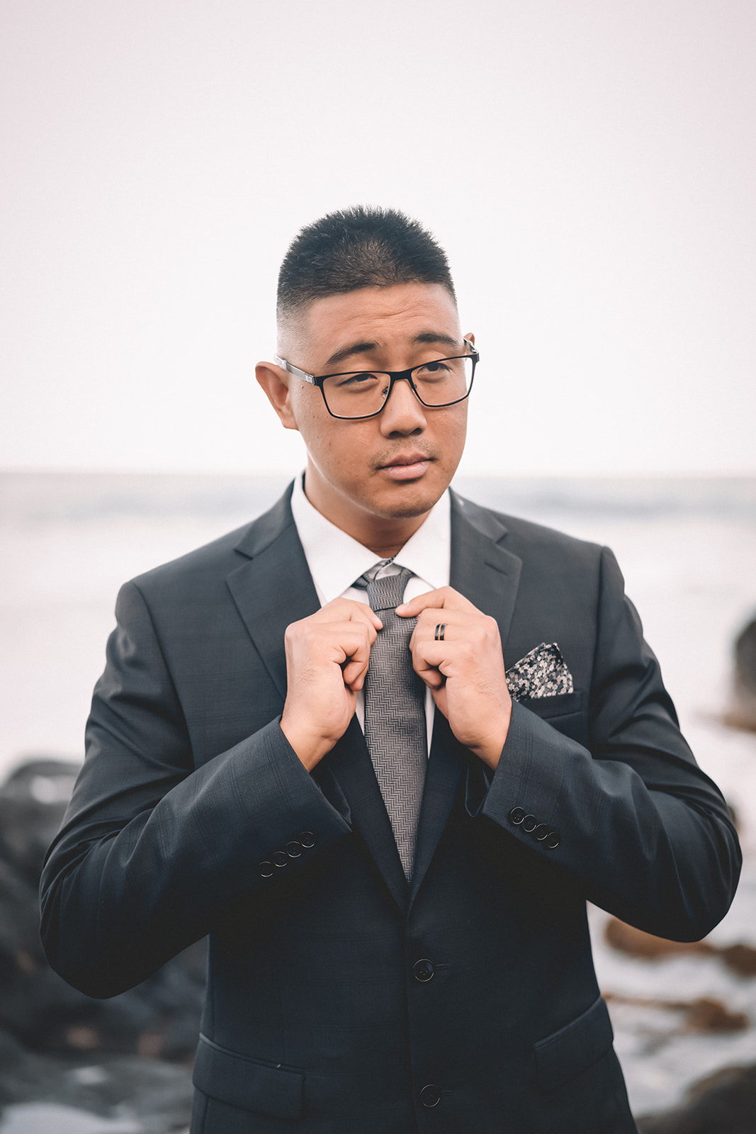man adjusting his tie