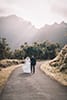 bride and groom walking towards sunset hoomaluhia botanical garden
