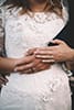 bride and groom holding hands showing wedding rings