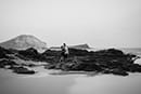Black and white couple standing on rocks makapuu beach