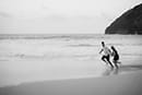 Black and white photo couple running shoreline makapuu beach hawaii