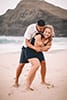man hugging woman laughing smiling makapuu beach 