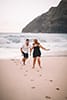 man chasing woman makapuu beach footprints in sand