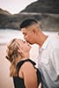 Man kissing fiancée on nose makapuu beach Hawaii engagement 