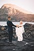 bride and groom holding hands rocks makapuu beach