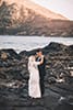 bride and groom holding eachother makapuu beach