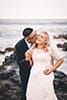 man kissing bride to be giggling makapuu beach