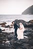 bride and groom walking on rocks makapuu beach hawaii