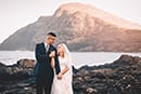 bride and groom holding hands gazing at eachother makapuu beach hawaii