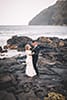 couple standing on rocks makapuu beach hawaii dancing