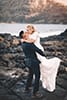 groom holding bride kissing makapuu beach