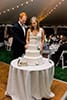 Couple cutting wedding cake 